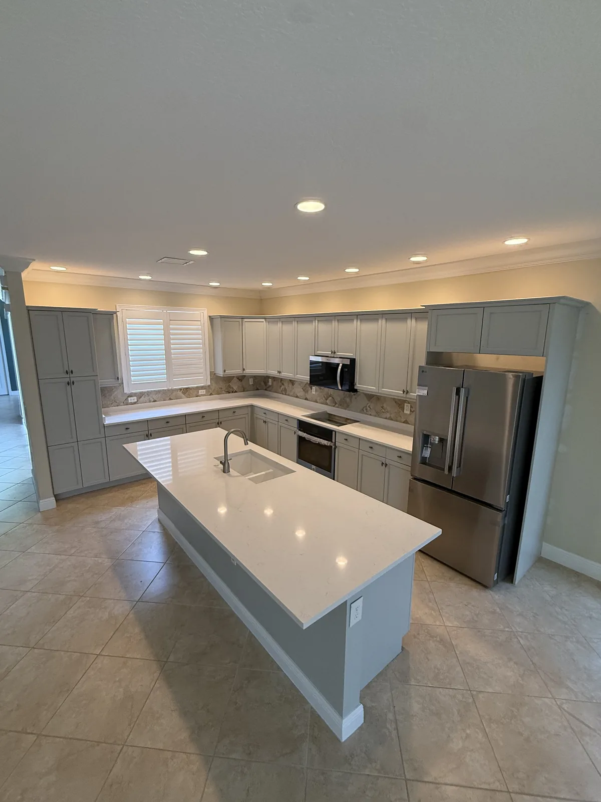 Grey refinished cabinets with a large island