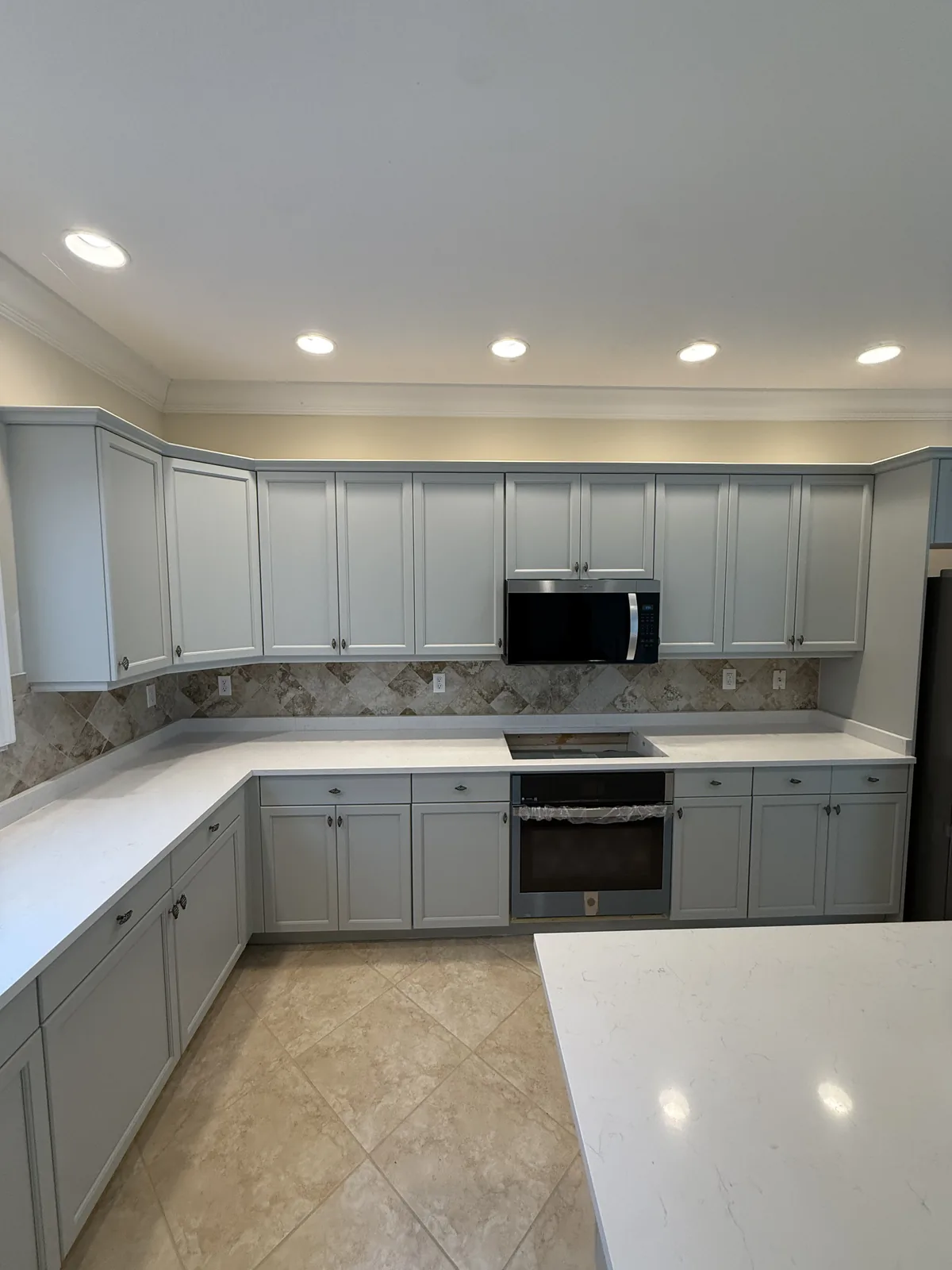 Soft grey cabinets and quartz countertops