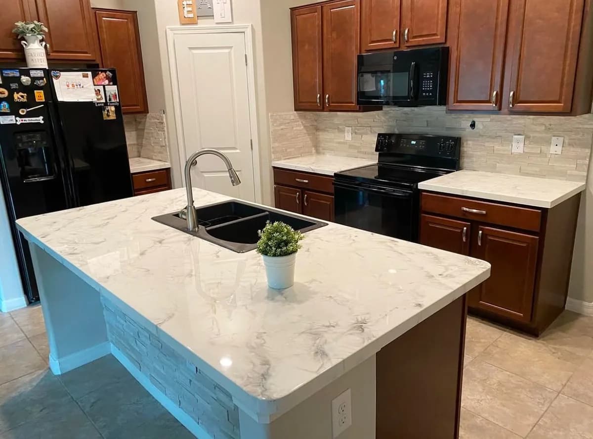 Refinished cabinets with marble waterfall island