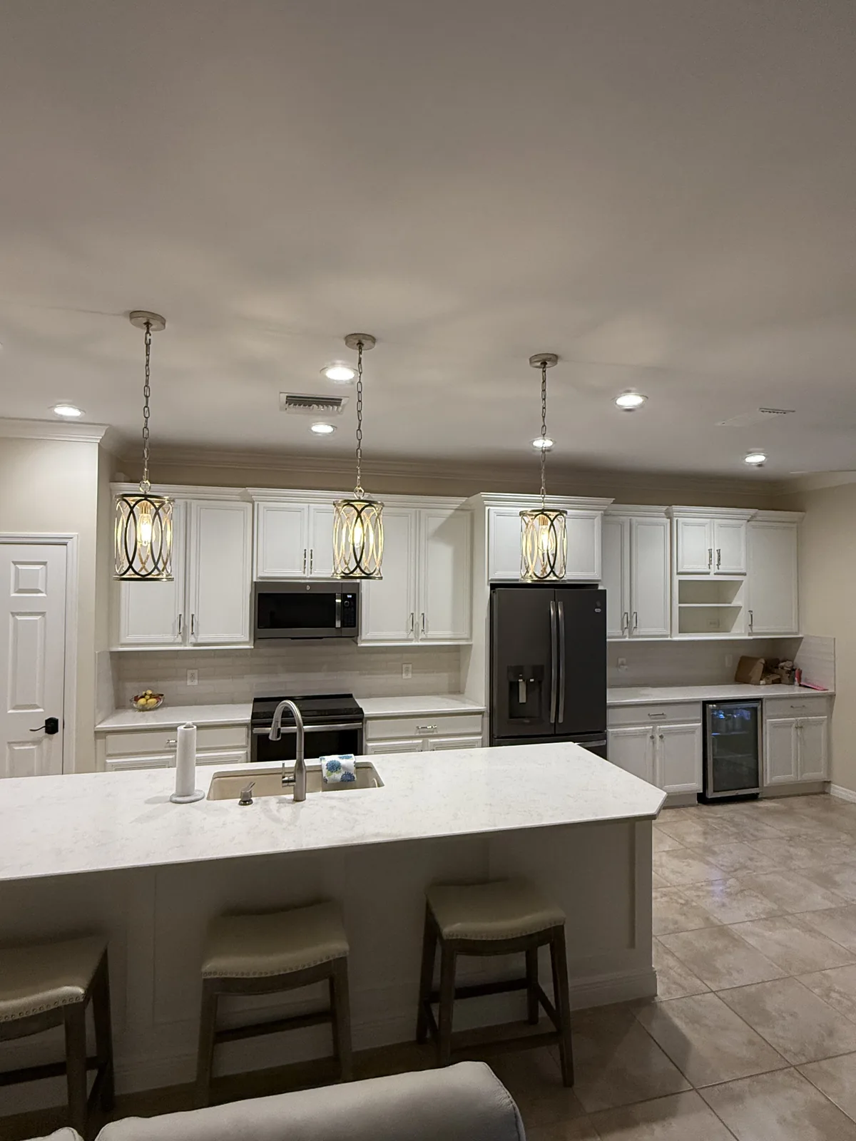 Refinished white kitchen cabinets with quartz counters