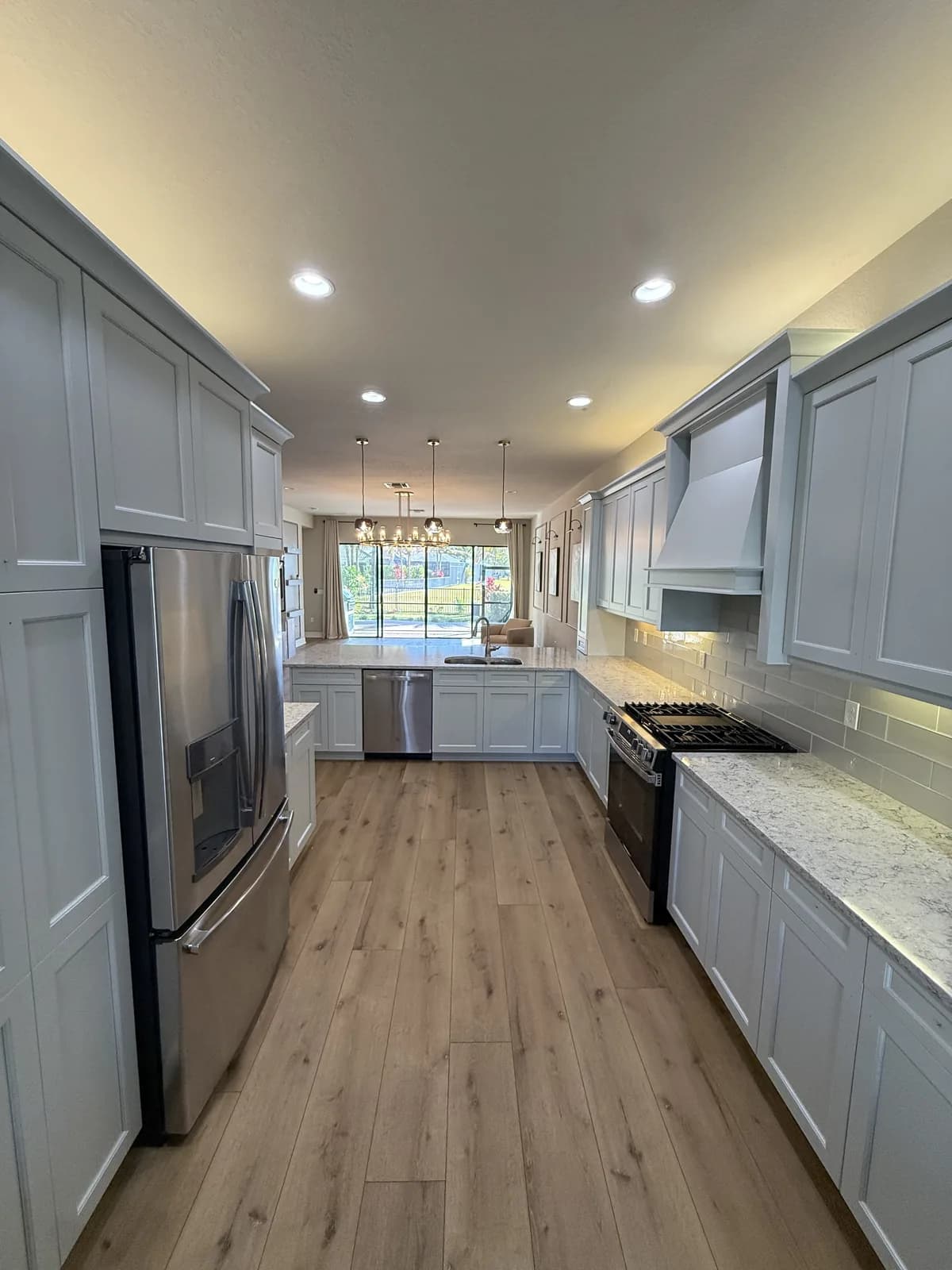 Finished white kitchen cabinets by Paint On Painting